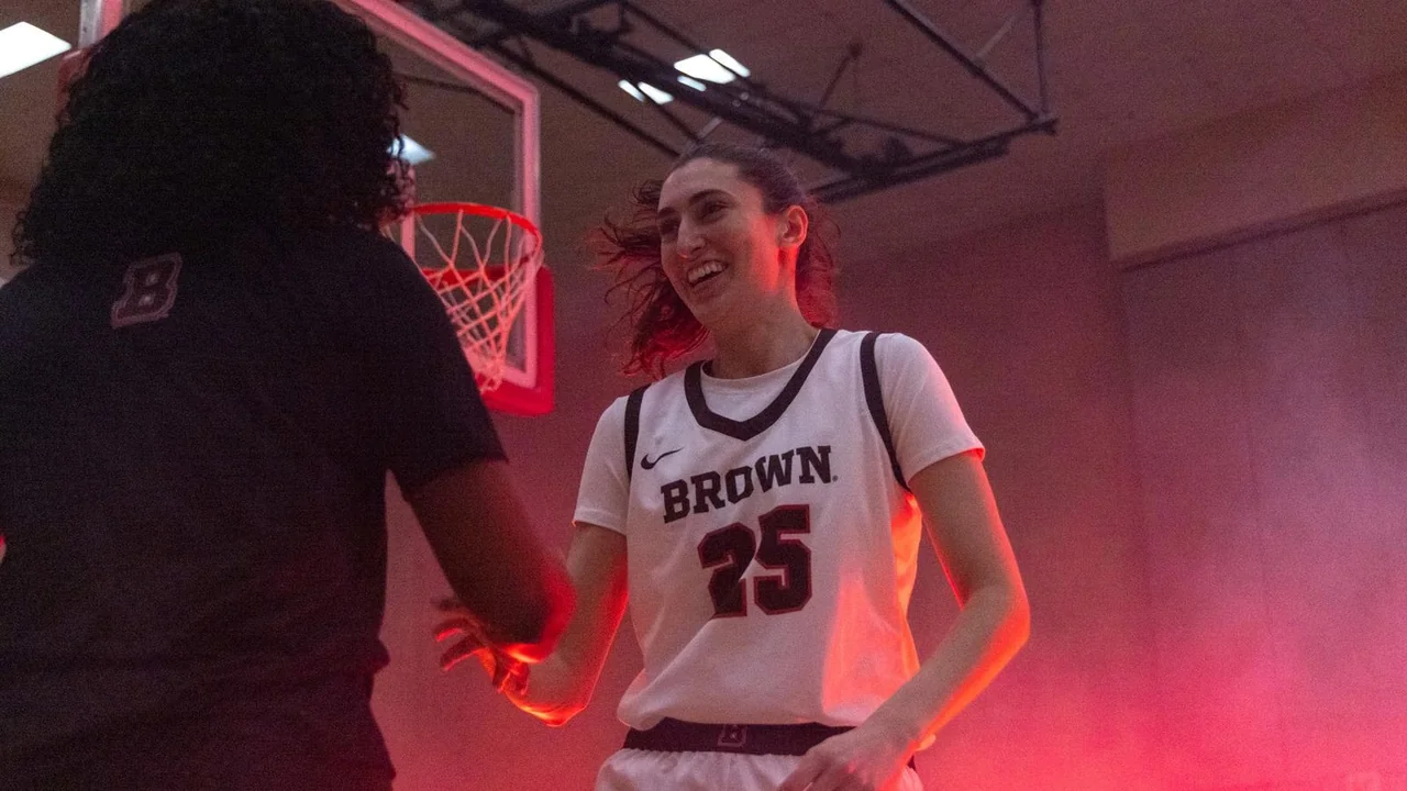 Brown Bears women's basketball: player posing in uniform for a studio portrait