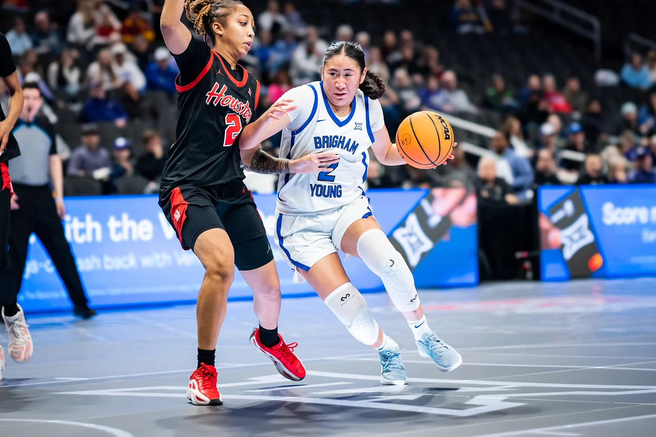 BYU Cougars women's basketball: guard dribbling during a game against an opponent