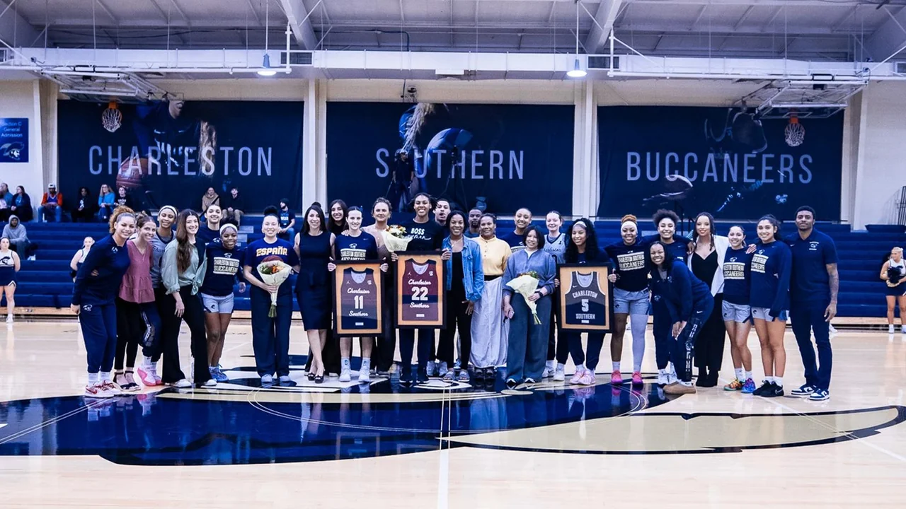 Charleston Southern Buccaneers women's basketball: players and staff posing together on the home court