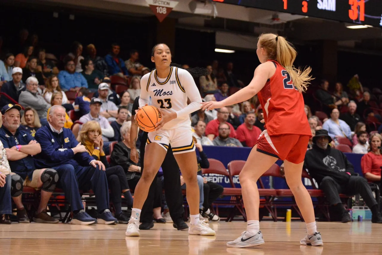 Chattanooga Mocs women's basketball: player driving past a defender during a game