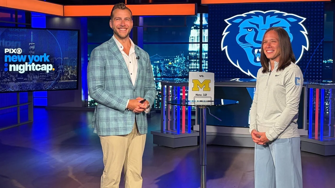 Columbia Lions women's basketball: two representatives posing beside Columbia athletics graphics
