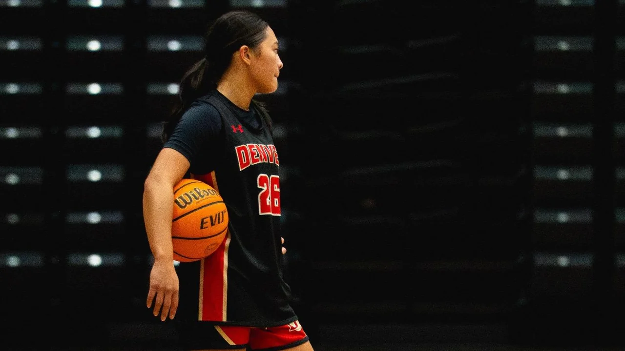 Denver Pioneers women's basketball: player holding a basketball during a studio portrait