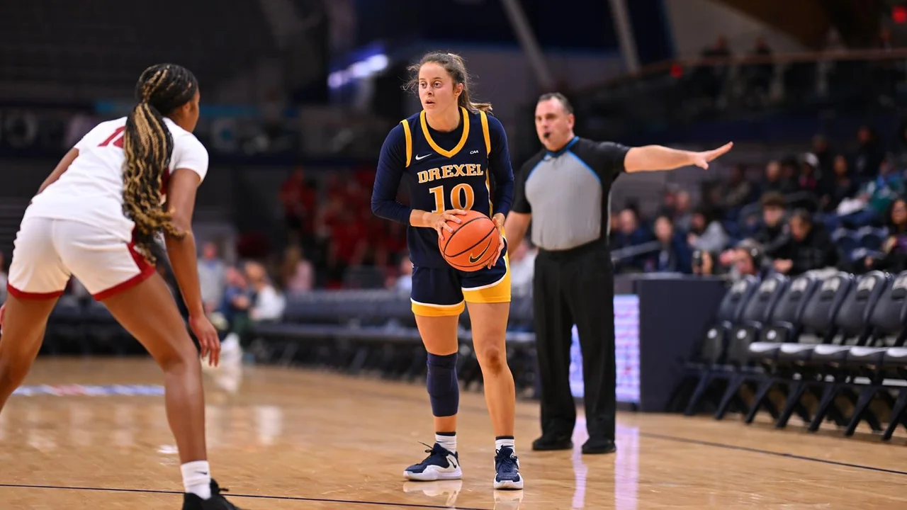 Drexel Dragons women's basketball: player dribbling while an opponent defends
