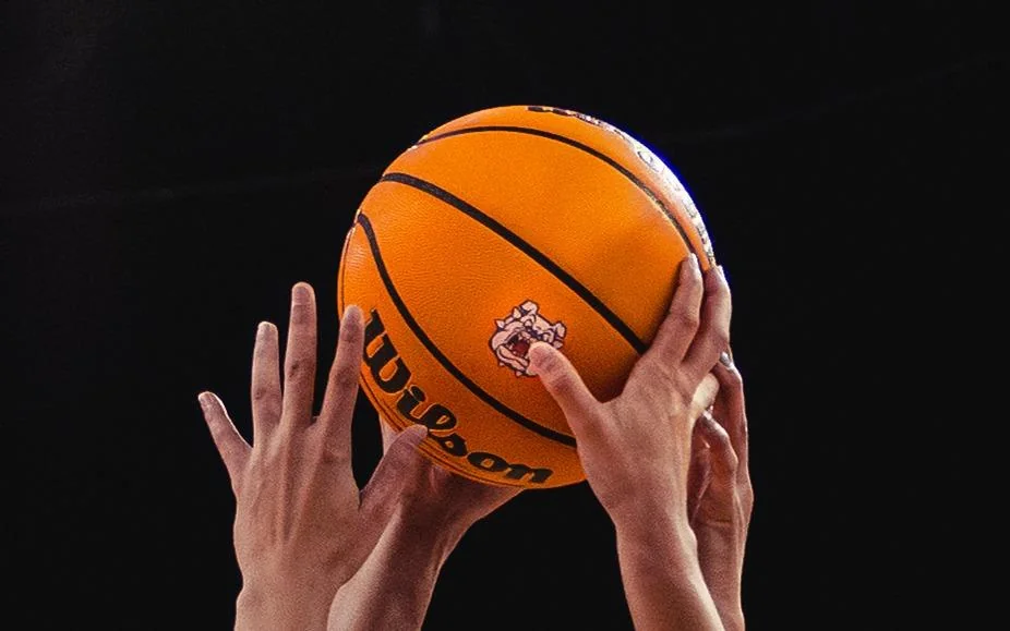 Fresno State Bulldogs women's basketball: close view of hands reaching toward a basketball