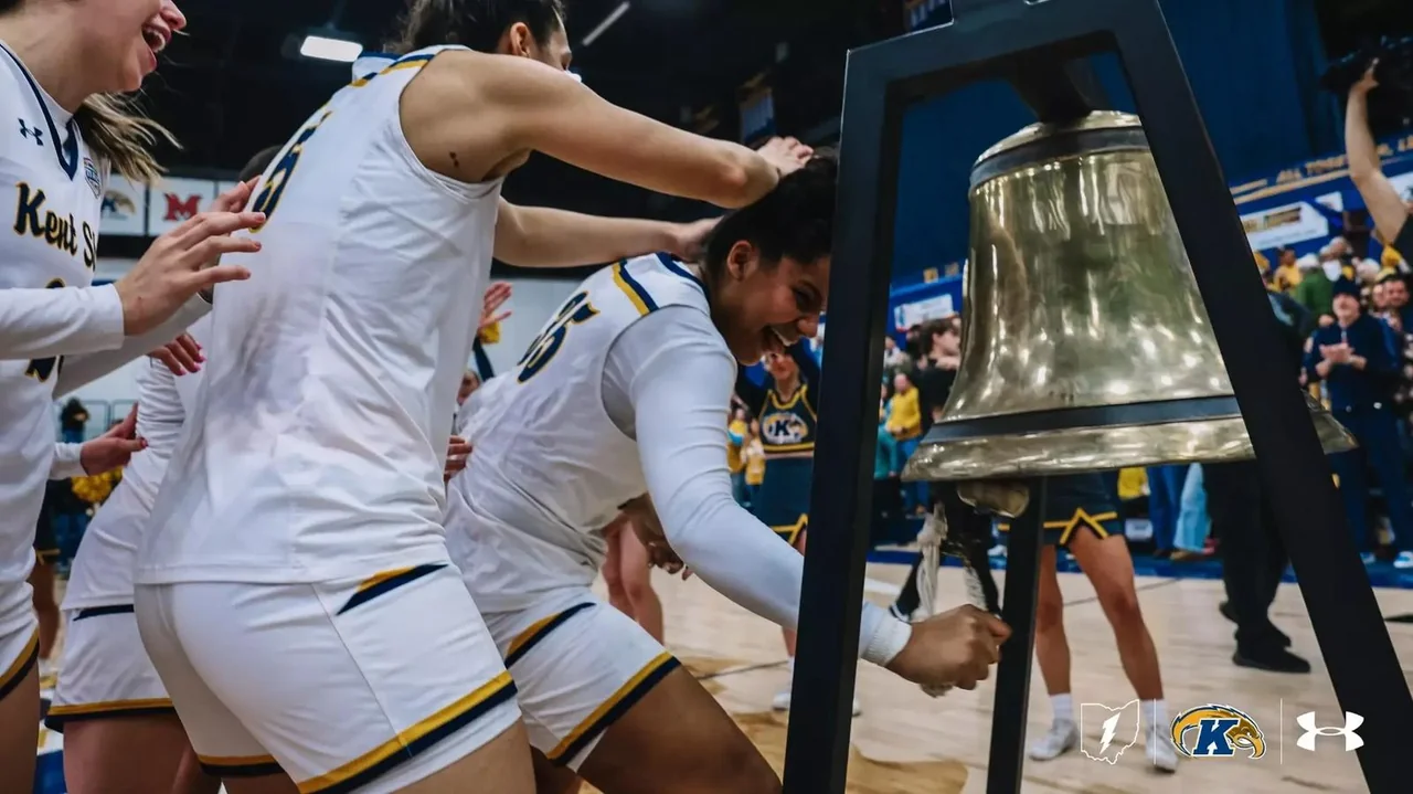 Kent State Golden Flashes women's basketball: players celebrating together beside a large bell