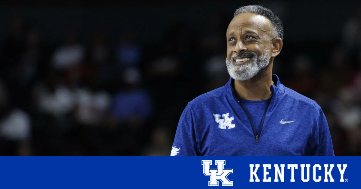 Kentucky Wildcats women's basketball: coach smiling while speaking at a media event