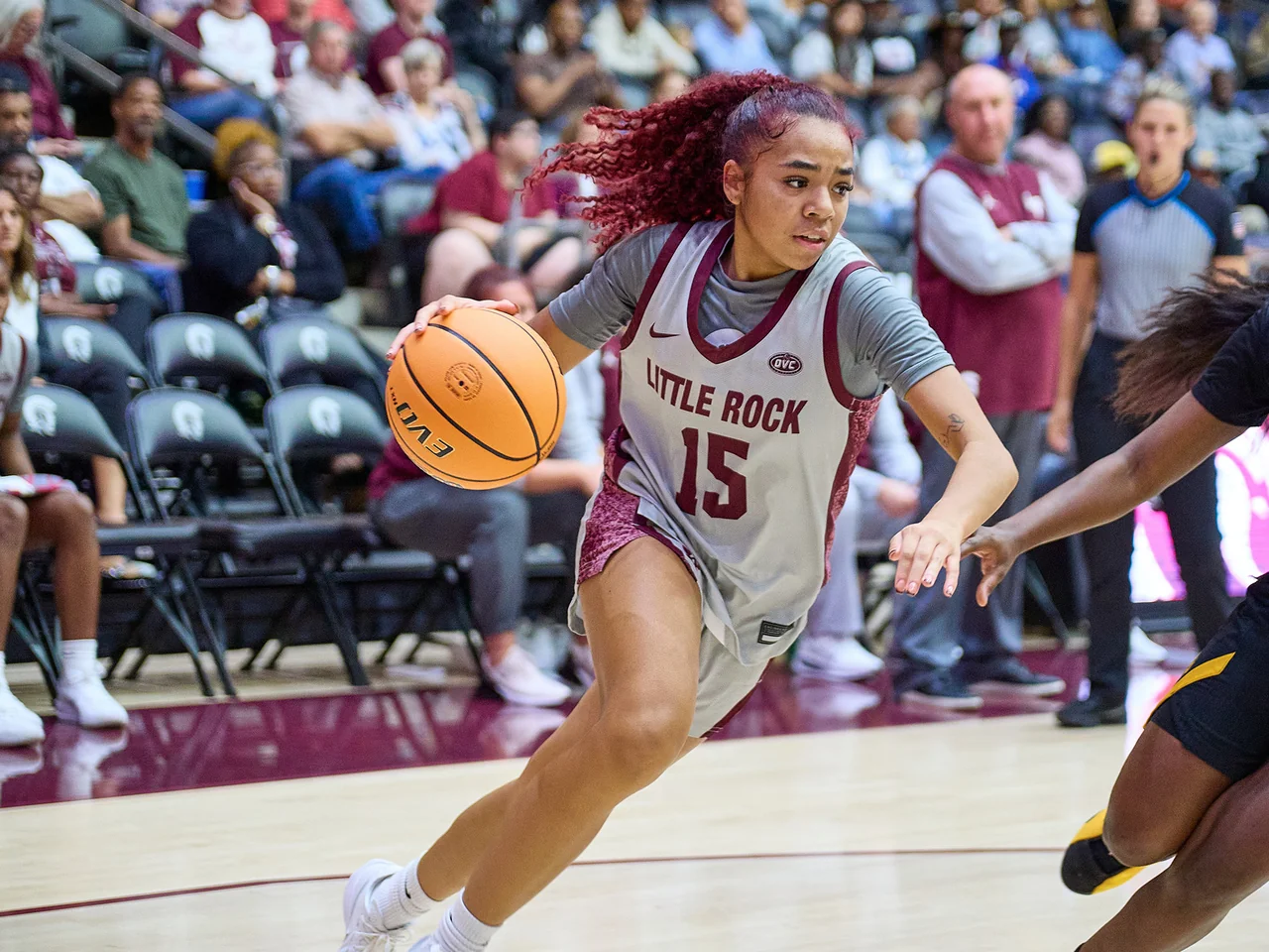 Little Rock Trojans women's basketball: player dribbling past an opponent during a game