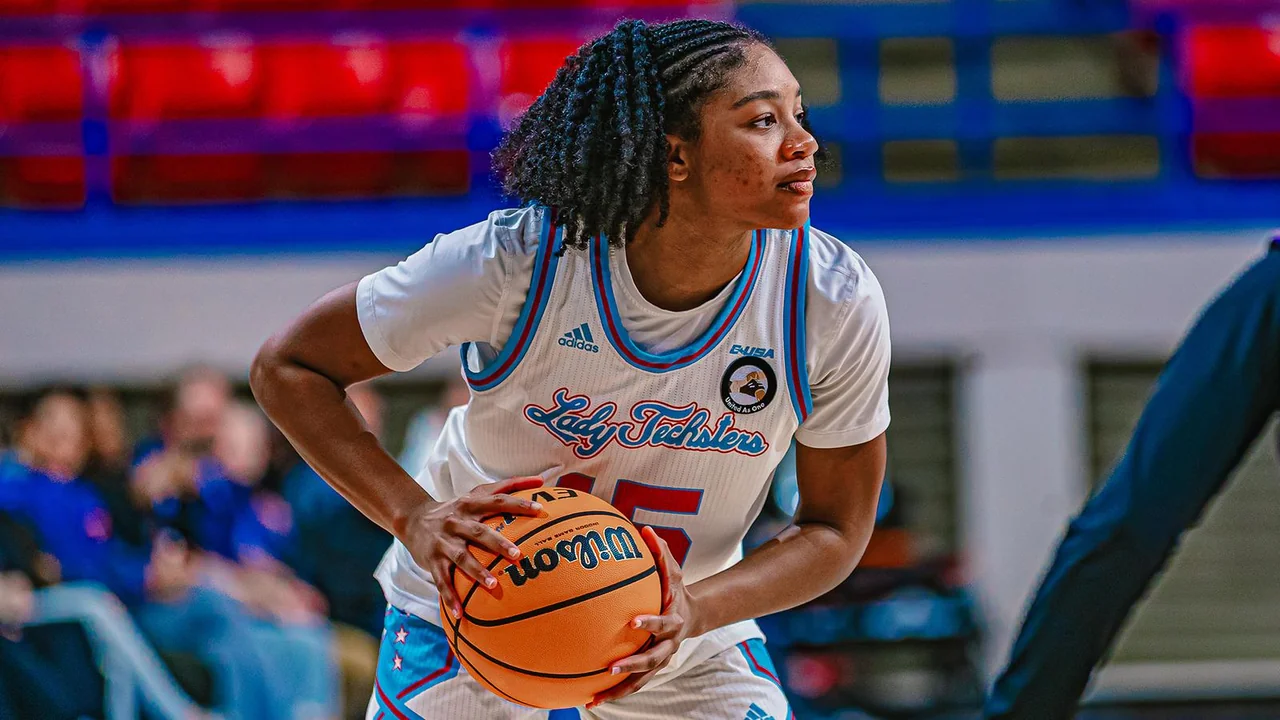 Louisiana Tech Lady Techsters women's basketball: player holding the basketball while looking toward the court