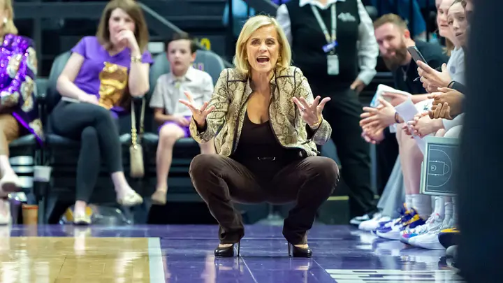 LSU Tigers broadcast crew at courtside with a player during a game at the Pete Maravich Assembly Center