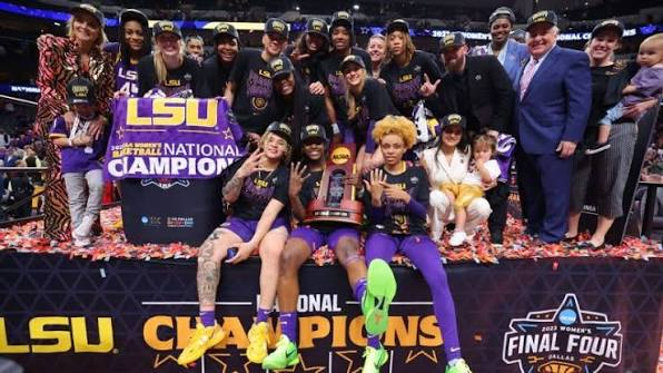 LSU Tigers players and staff posing with the NCAA National Championship trophy after winning the 2023 title in Dallas