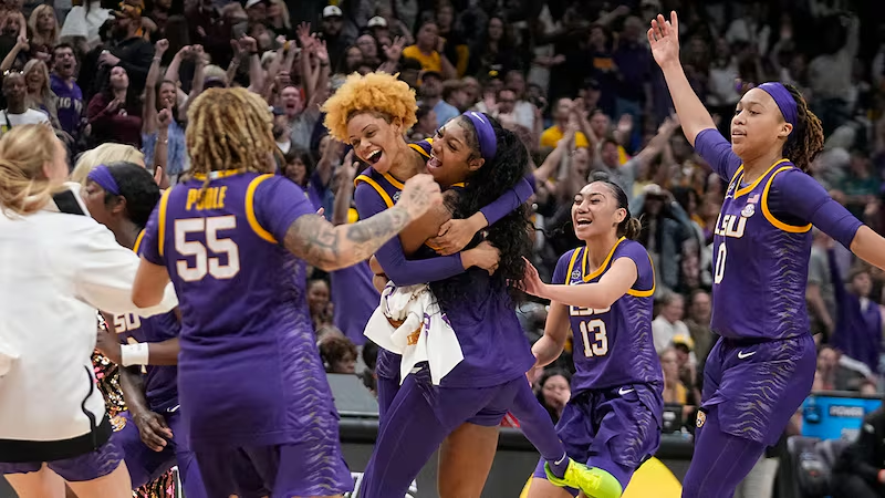 LSU Tigers players hugging and celebrating together on the court during a tournament game
