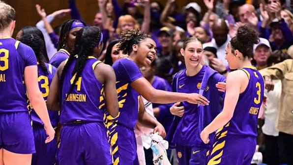 LSU Tigers players celebrating together in a huddle during a game
