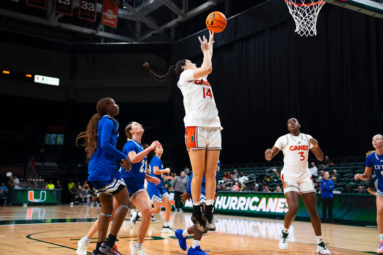 Miami Hurricanes women's basketball: player extending for a layup near the basket