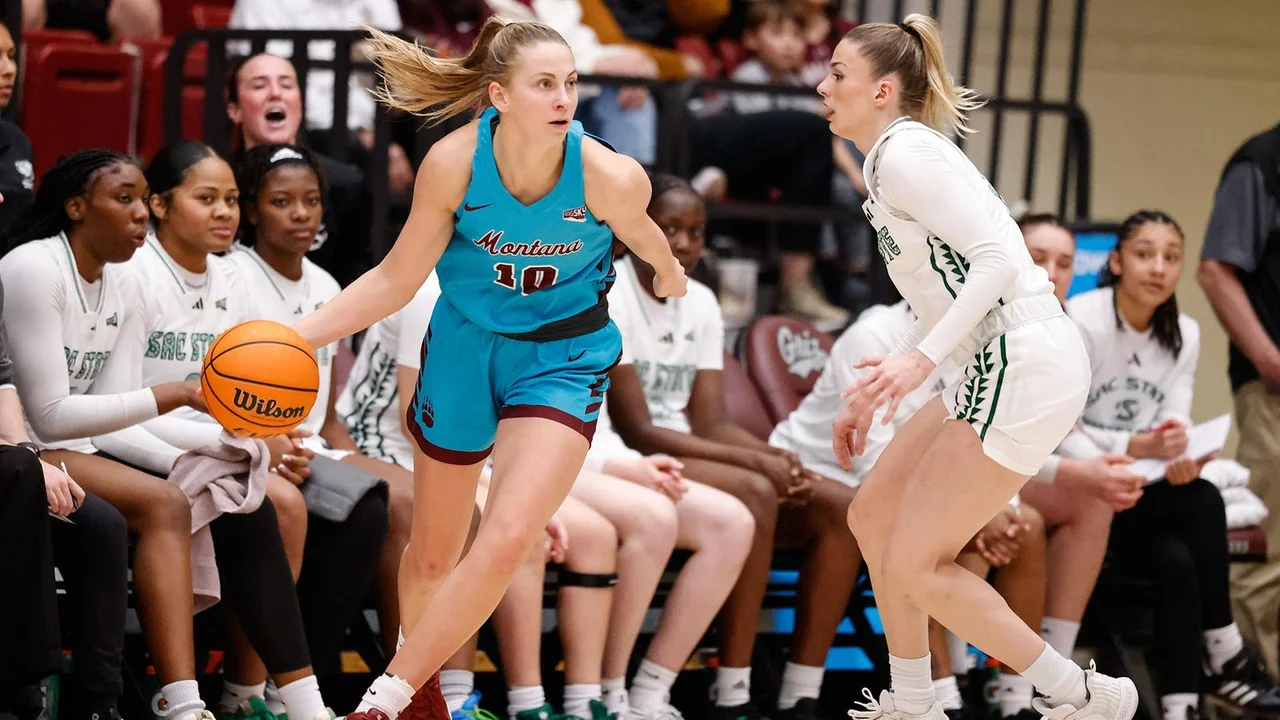 Montana Lady Griz women's basketball: guard dribbling in front of the team bench during a game