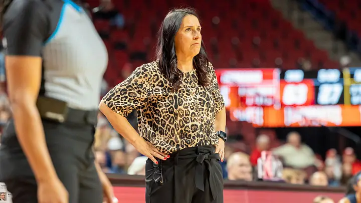 Nebraska head coach Amy Williams watching play from the sideline during a road game