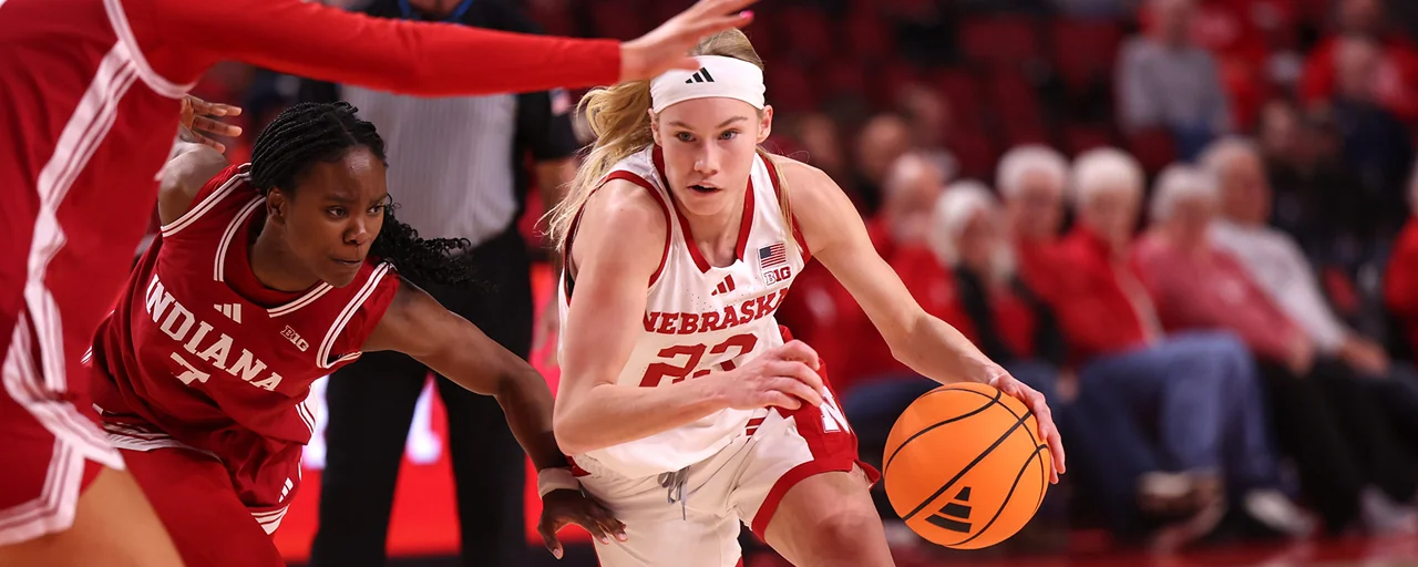 Nebraska Cornhuskers women's basketball: player driving past a defender in a home game