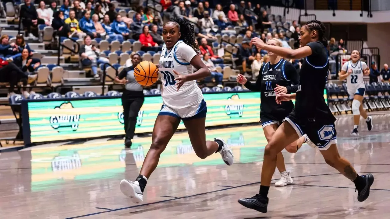 North Florida Ospreys women's basketball: player holding the basketball while facing a defender