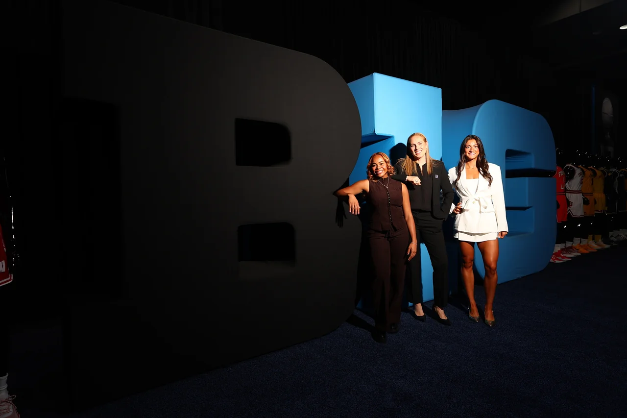 Northwestern Wildcats women's basketball: three representatives posing beside Big Ten lettering