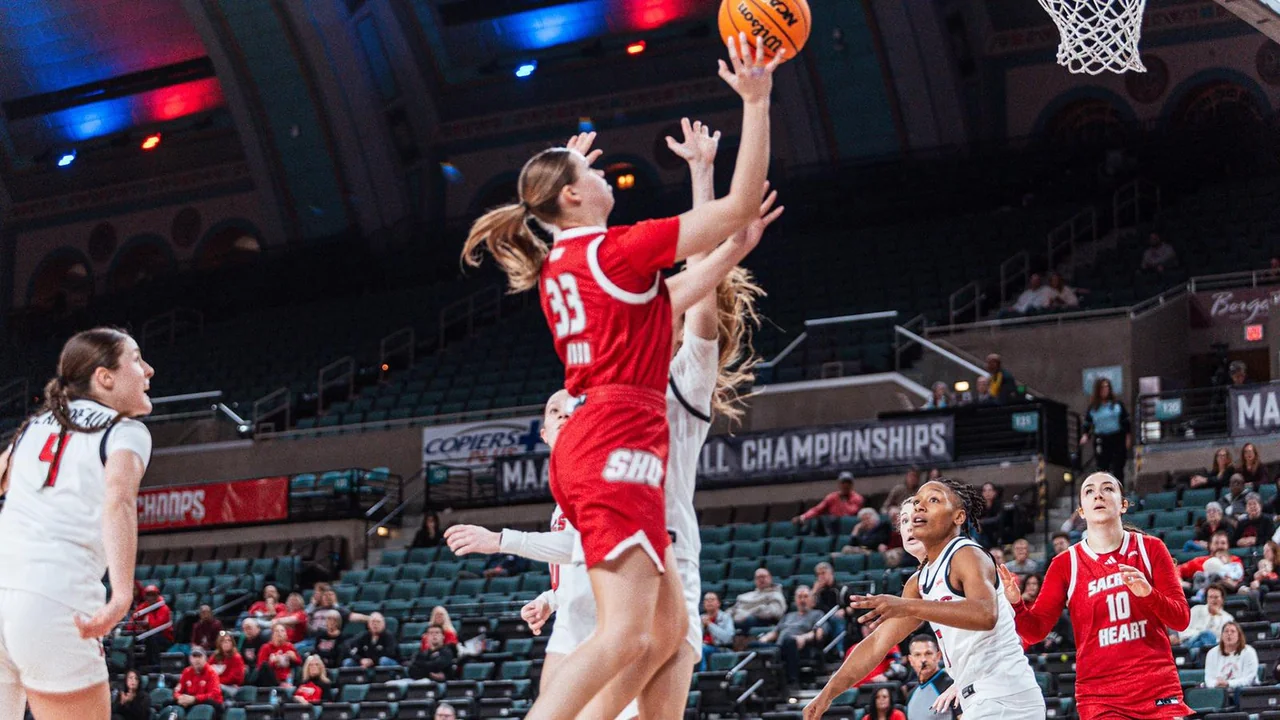 Sacred Heart Pioneers women's basketball: player extending for a layup near the basket