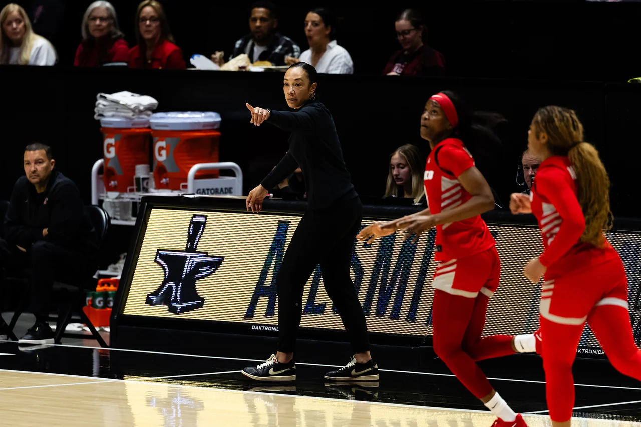 San Diego State Aztecs women's basketball: player dribbling while a defender guards closely