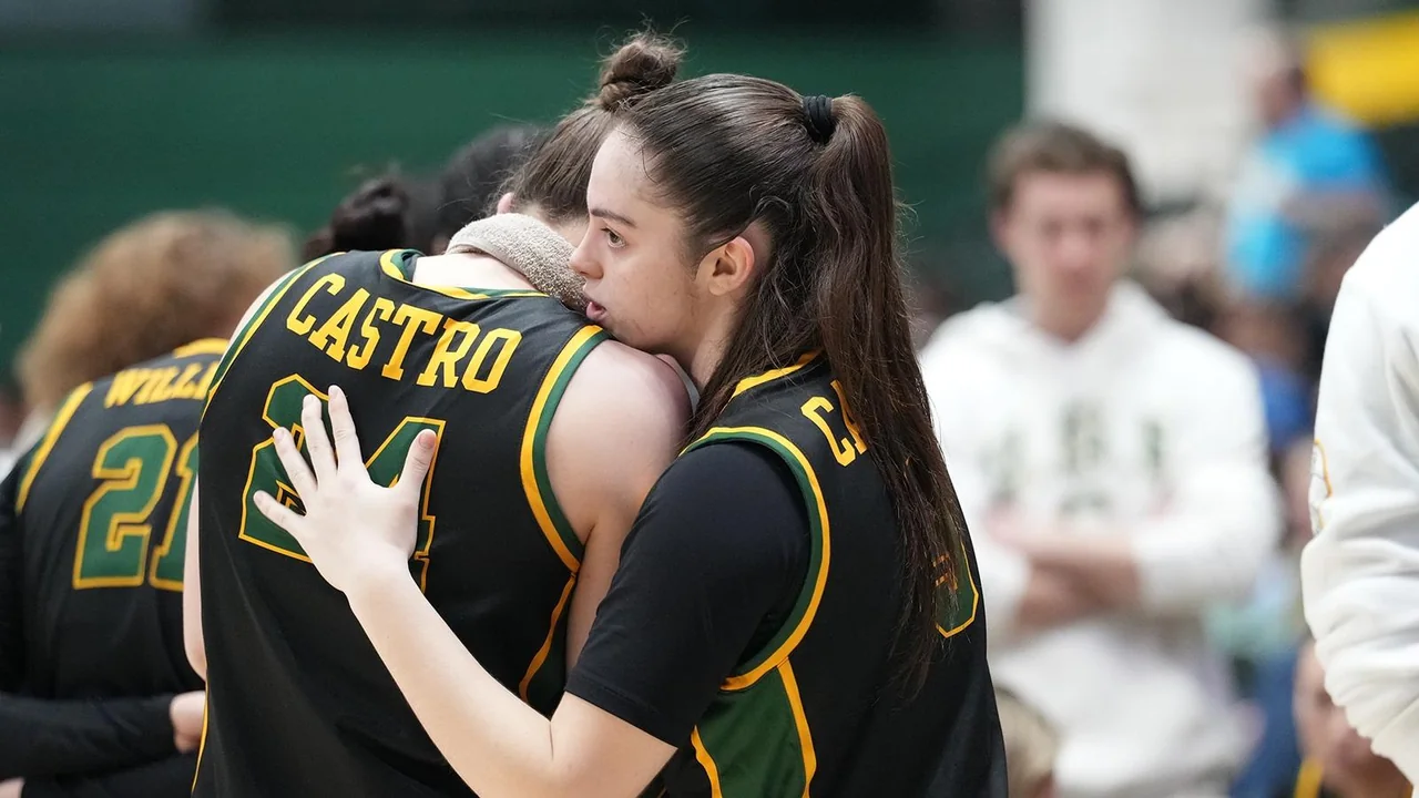 San Francisco Dons women's basketball: players embracing beside the court