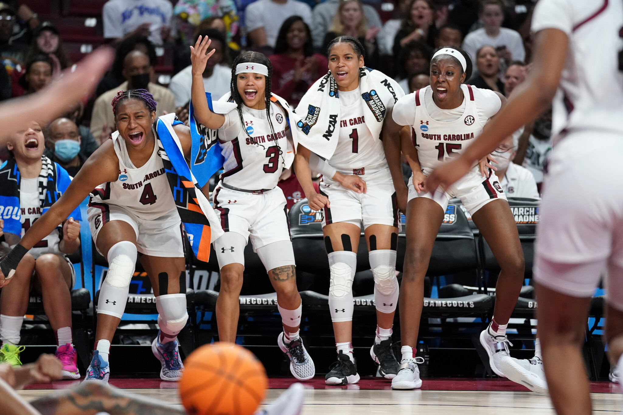 South Carolina Gamecocks bench players celebrating during an NCAA Tournament game at Colonial Life Arena