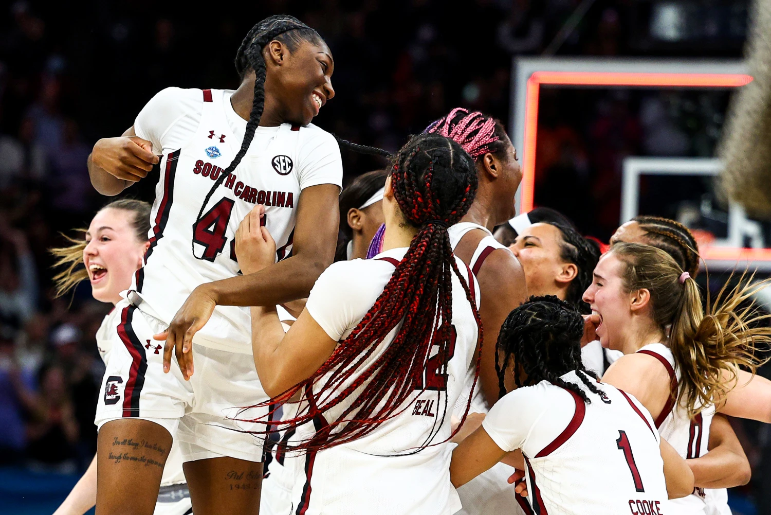 South Carolina Gamecocks players celebrating together on the court after a tournament win