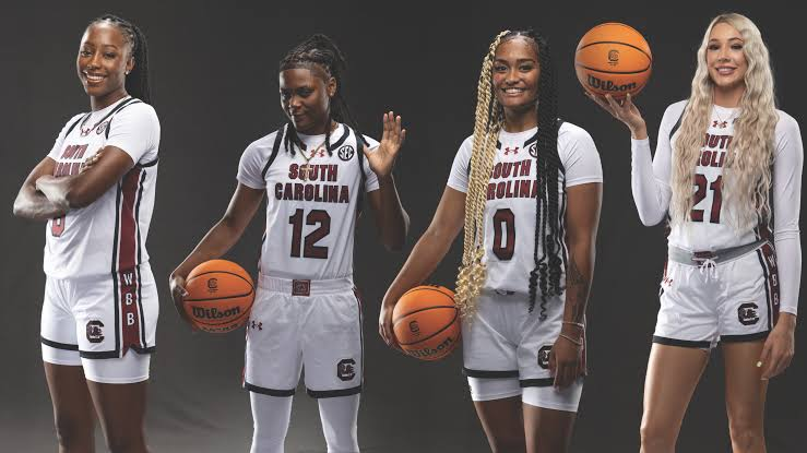 Four South Carolina Gamecocks players posing with basketballs in studio portraits ahead of the season