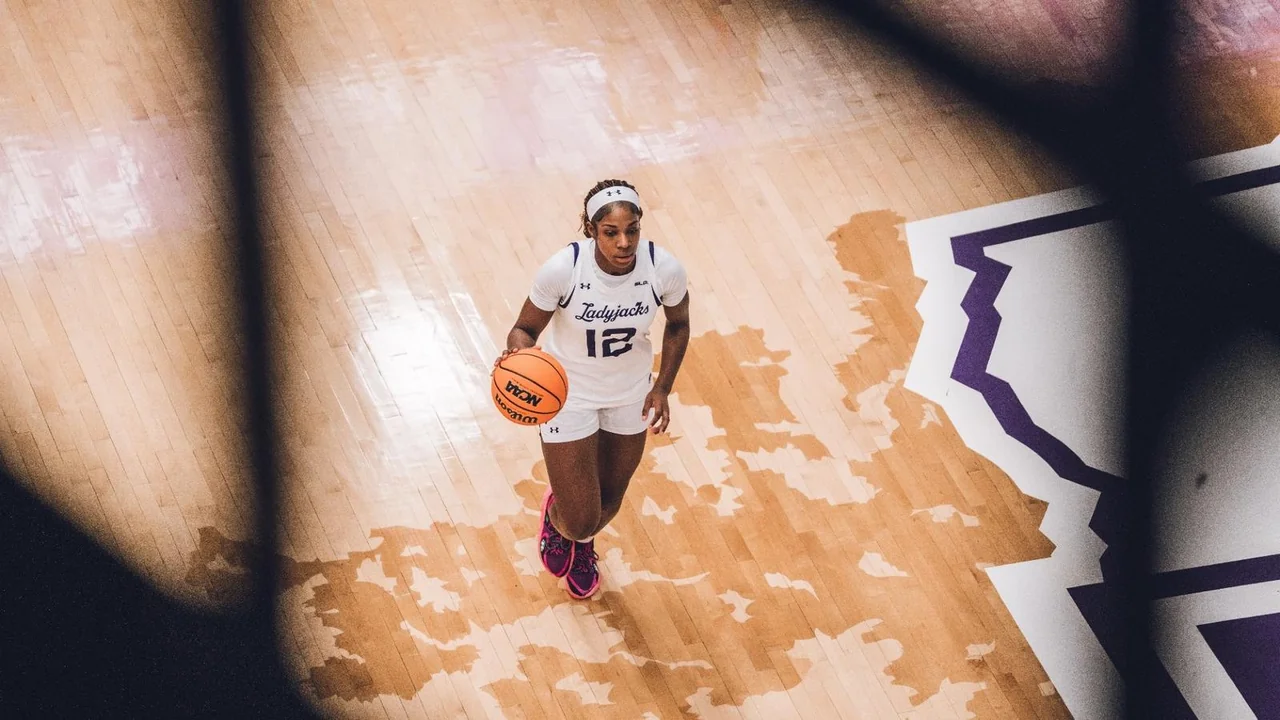 Stephen F. Austin Ladyjacks women's basketball: player dribbling on the home basketball court