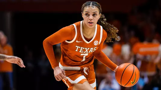 Texas Longhorns guard driving with the ball during a home game at the Moody Center