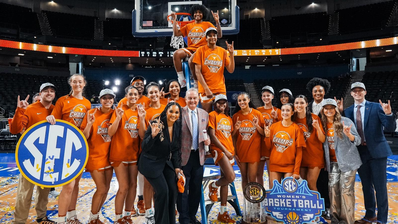 Texas Longhorns players and staff celebrating the 2026 SEC championship with net-cutting and a trophy