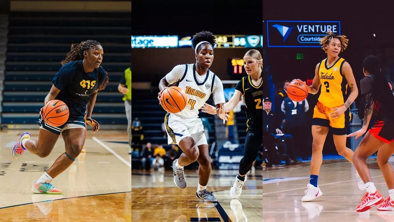 Toledo Rockets women's basketball: player advancing with the ball between defenders