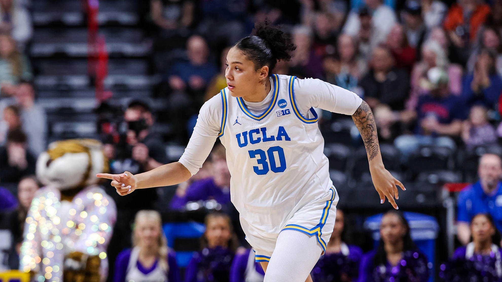 UCLA Bruins guard celebrating and pointing after a play during an NCAA Tournament game