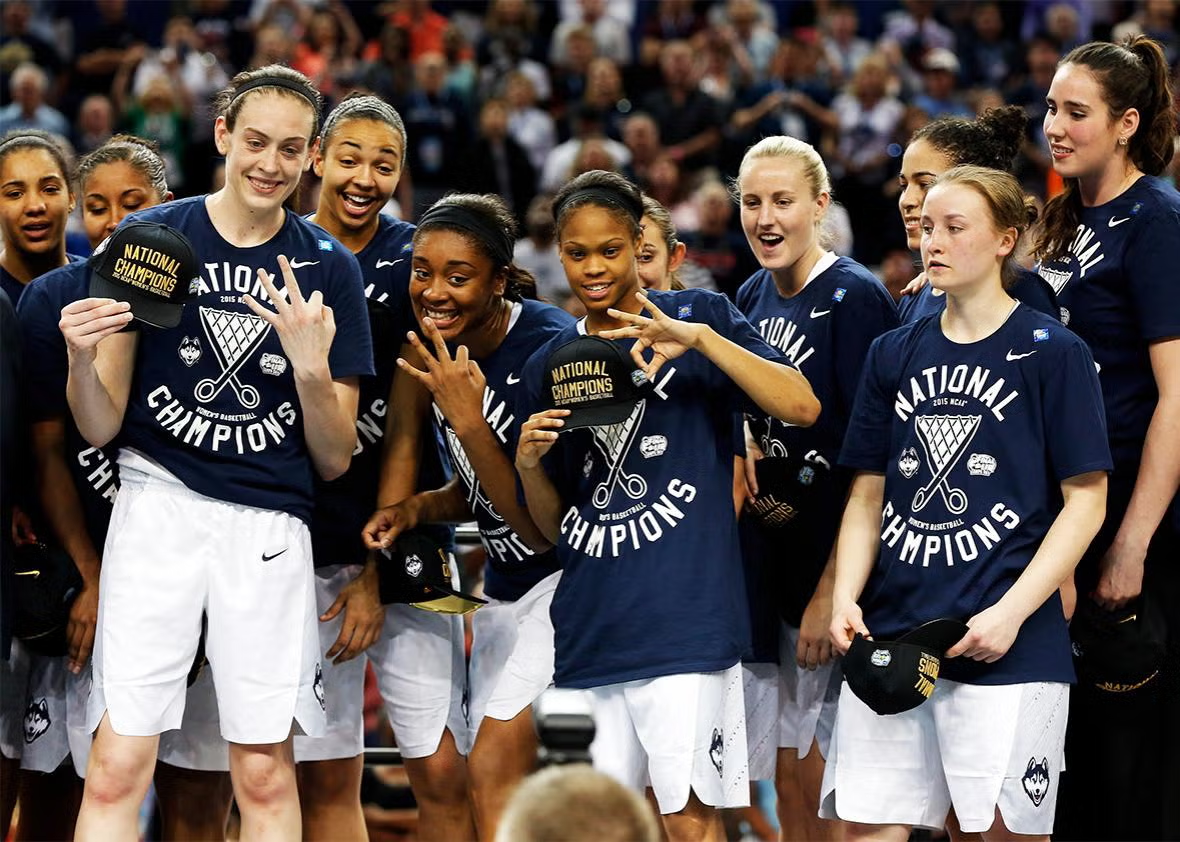 UConn Huskies players wearing 2015 NCAA National Champions t-shirts and caps celebrating on the court