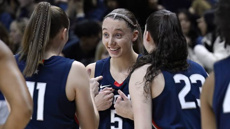 UConn Huskies players sharing a moment together during a game huddle