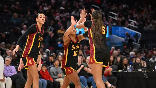 USC Trojans players high-fiving each other during an NCAA Tournament game