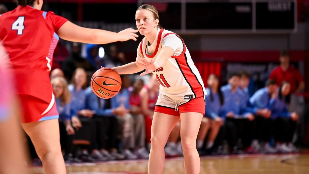 Western Kentucky Lady Toppers women's basketball: player dribbling past a defender during a game