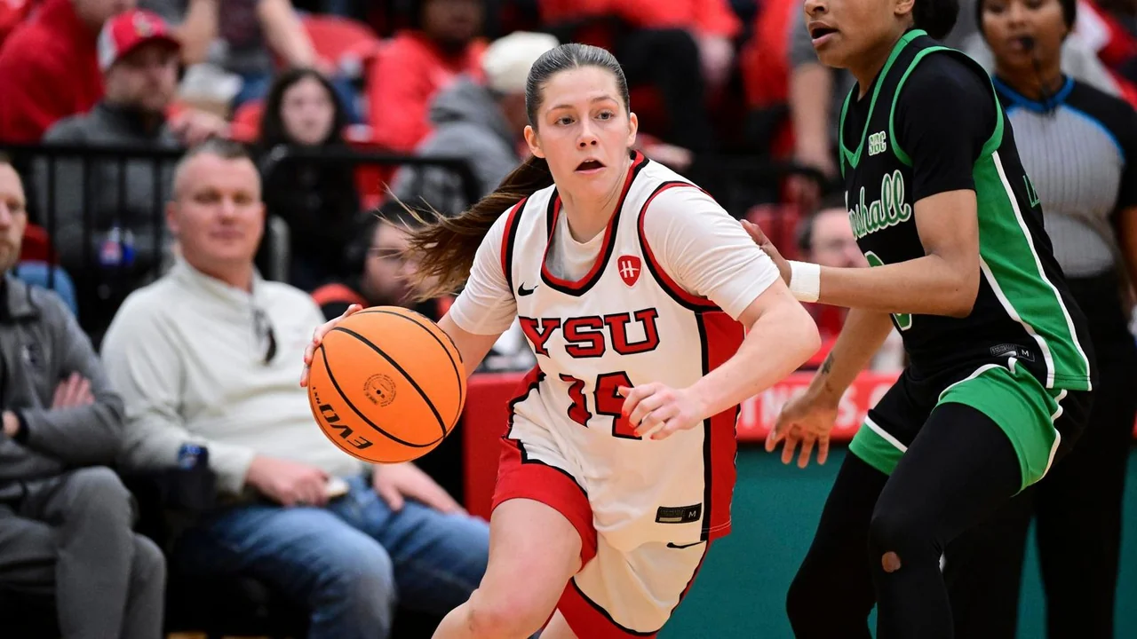 Youngstown State Penguins women's basketball: player controlling the basketball while facing a defender